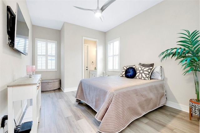 bedroom featuring light wood-type flooring, multiple windows, and baseboards