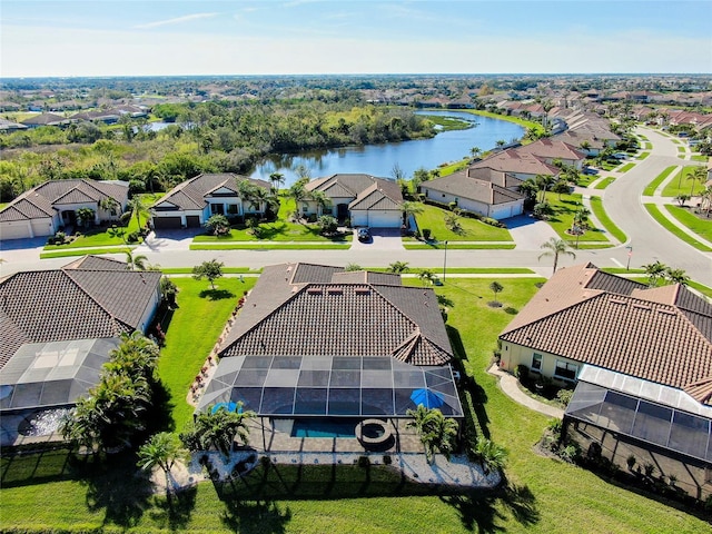 drone / aerial view featuring a water view and a residential view