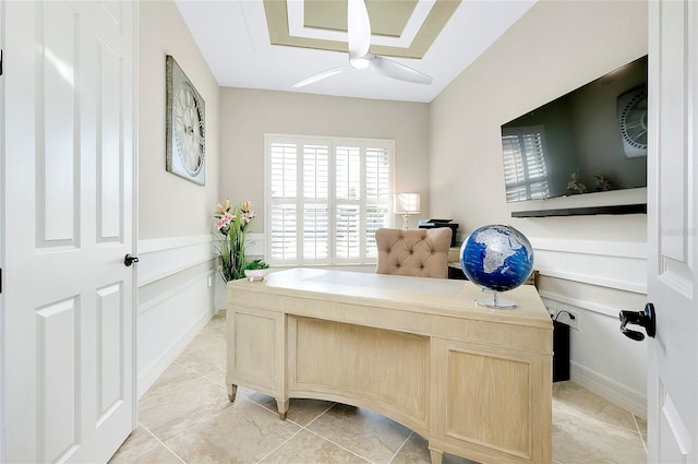 office space featuring wainscoting and a decorative wall