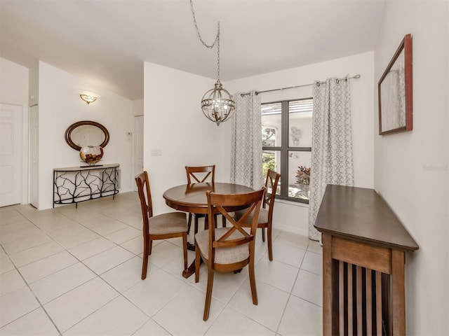 dining room with light tile patterned floors, baseboards, and a notable chandelier