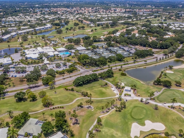 drone / aerial view with a water view and golf course view