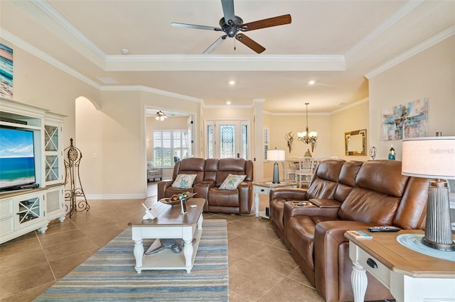 living room with ornamental molding, ceiling fan with notable chandelier, and light tile patterned floors