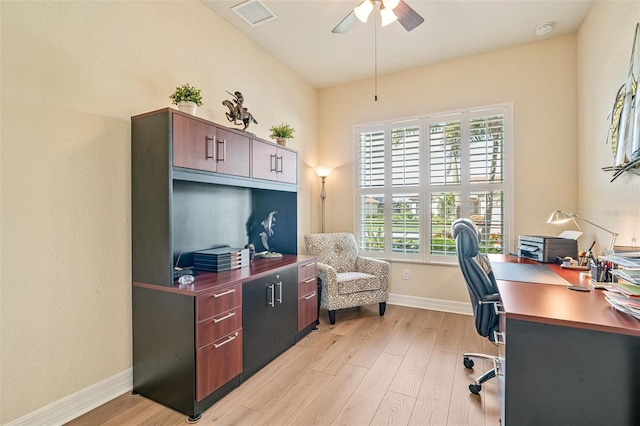 office area with ceiling fan, light wood-type flooring, visible vents, and baseboards