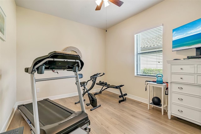 workout room featuring ceiling fan, light wood-type flooring, and baseboards