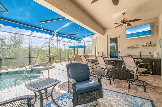 view of patio featuring outdoor dry bar, glass enclosure, and a pool with connected hot tub