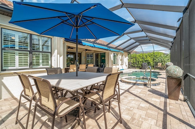 view of patio with a lanai, ceiling fan, a pool with connected hot tub, and outdoor dining area