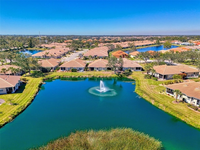 drone / aerial view featuring a residential view and a water view