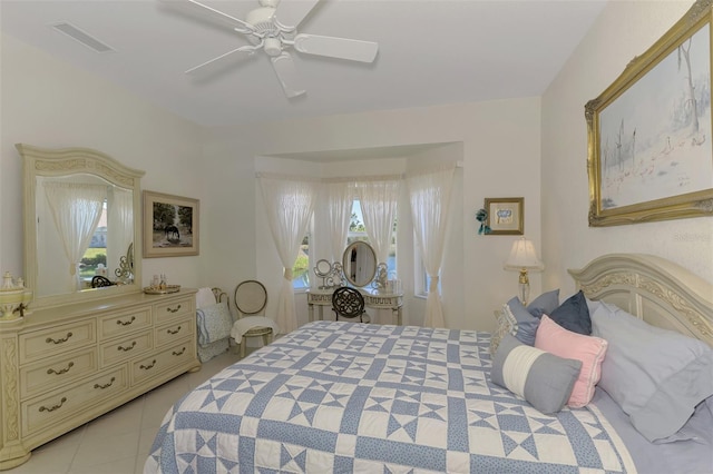 bedroom featuring light tile patterned floors, visible vents, and a ceiling fan