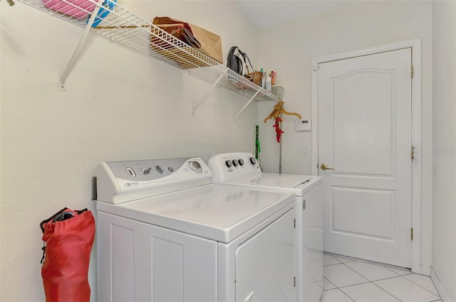 laundry area featuring laundry area, light tile patterned floors, and separate washer and dryer