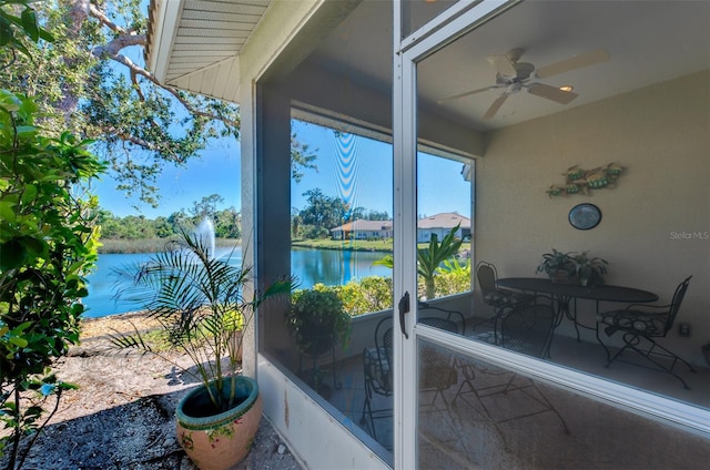 exterior space featuring a water view and a ceiling fan