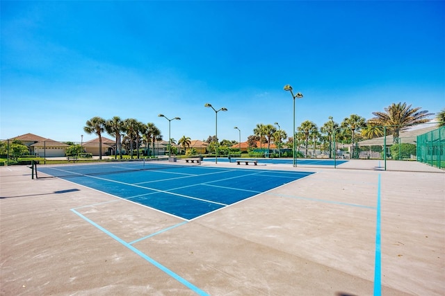 view of tennis court with fence