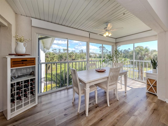 sunroom / solarium with wooden ceiling and a ceiling fan