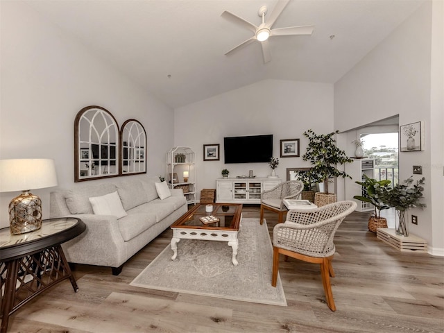 living room featuring ceiling fan, high vaulted ceiling, and wood finished floors