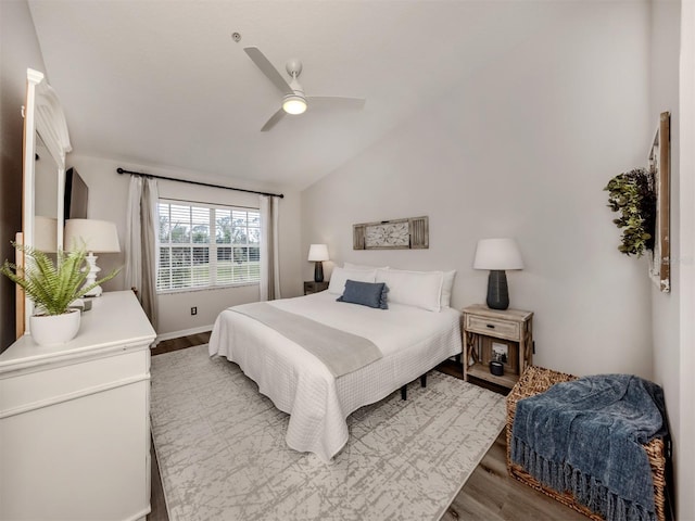 bedroom featuring a ceiling fan, vaulted ceiling, and wood finished floors