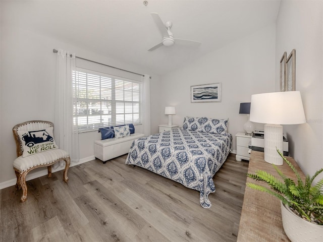 bedroom with vaulted ceiling, wood finished floors, a ceiling fan, and baseboards