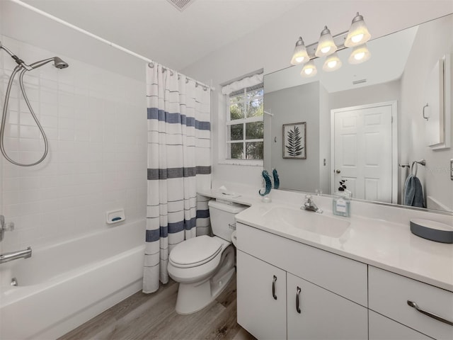 full bath featuring toilet, shower / bath combo, wood finished floors, and vanity