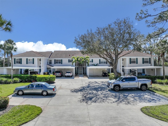 townhome / multi-family property with stairs and driveway