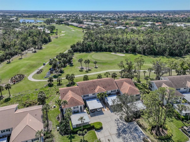 birds eye view of property with view of golf course and a water view