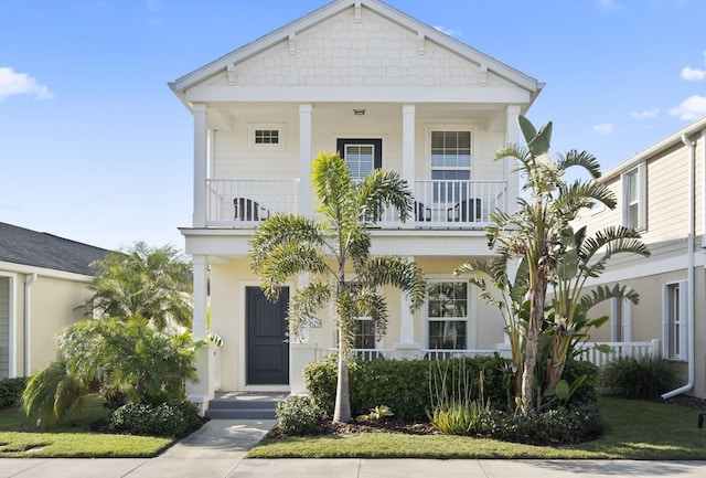 view of front of house featuring a balcony and stucco siding