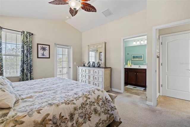 bedroom with ensuite bathroom, light carpet, visible vents, baseboards, and vaulted ceiling