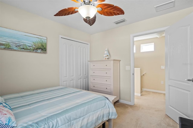 bedroom with light carpet, baseboards, visible vents, and a closet