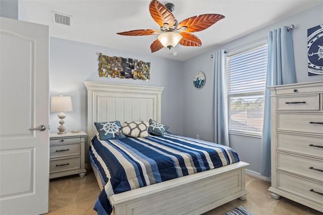 bedroom featuring ceiling fan, visible vents, and light colored carpet