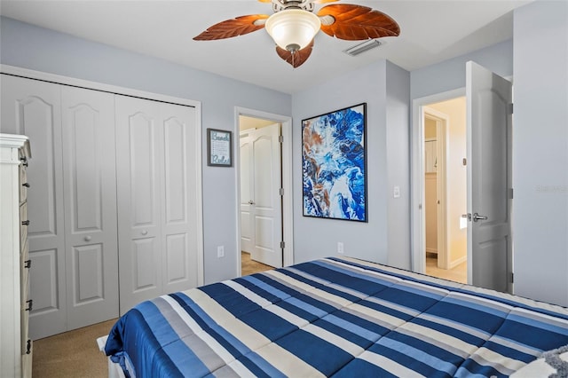 bedroom with ceiling fan, visible vents, a closet, and light colored carpet