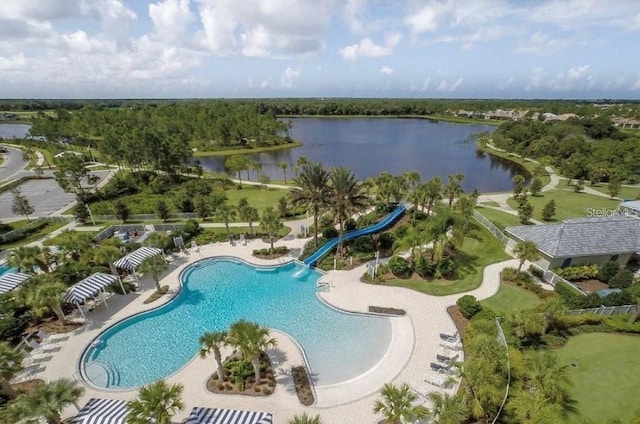 pool featuring a water view, a water slide, and a patio