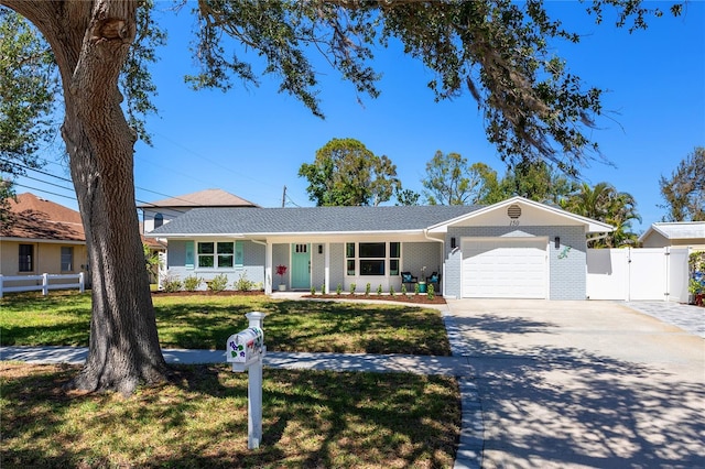 single story home with a gate, fence, concrete driveway, and an attached garage