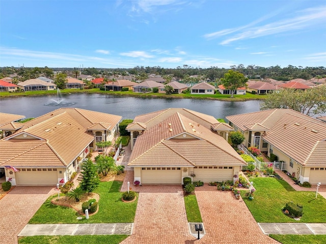 bird's eye view with a water view and a residential view