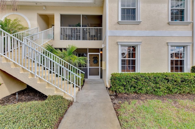 view of exterior entry featuring stucco siding