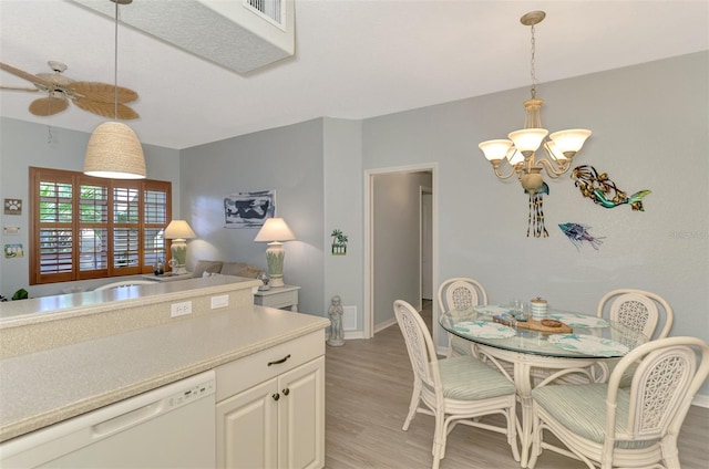 kitchen with pendant lighting, visible vents, dishwasher, and light wood-style flooring