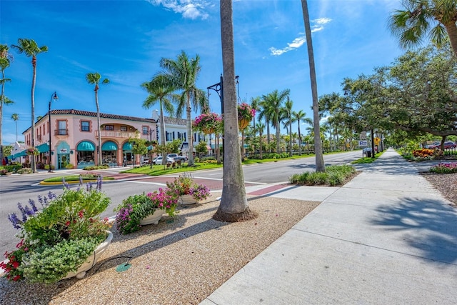 view of street featuring curbs, sidewalks, and street lights