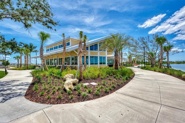 exterior space with driveway and a water view