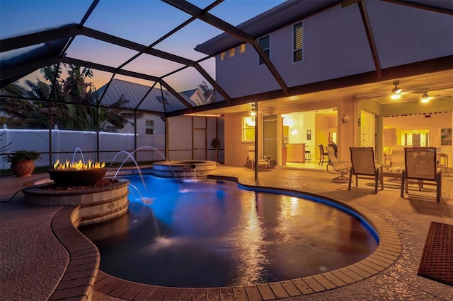 outdoor pool featuring an outdoor fire pit, glass enclosure, a patio, and an in ground hot tub