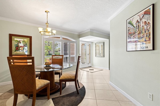 dining area featuring crown molding, a notable chandelier, light tile patterned flooring, a textured ceiling, and baseboards