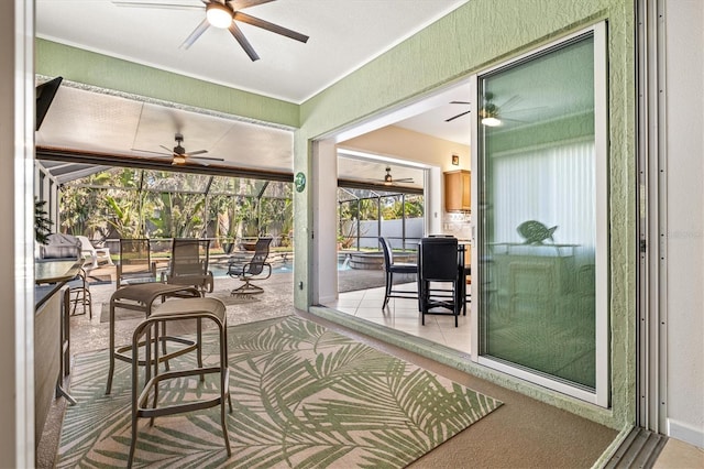 sunroom / solarium featuring ceiling fan