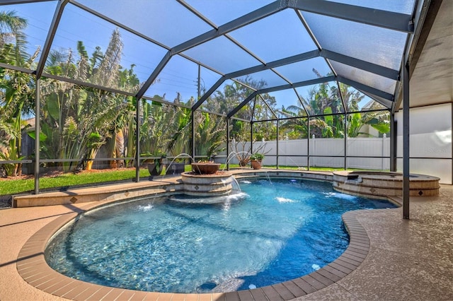 view of pool with a patio area, fence, a pool with connected hot tub, and a lanai