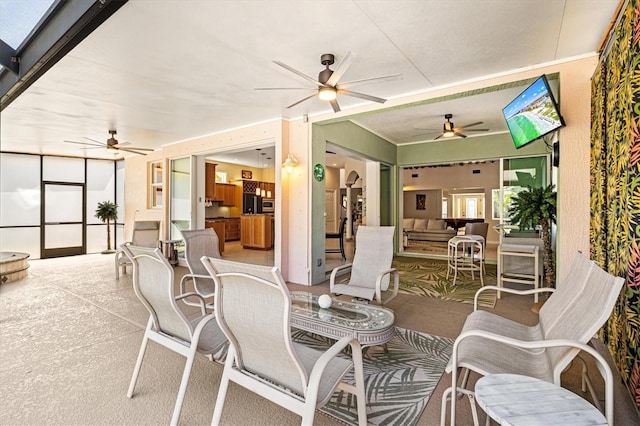 view of patio / terrace with a ceiling fan and outdoor dining space