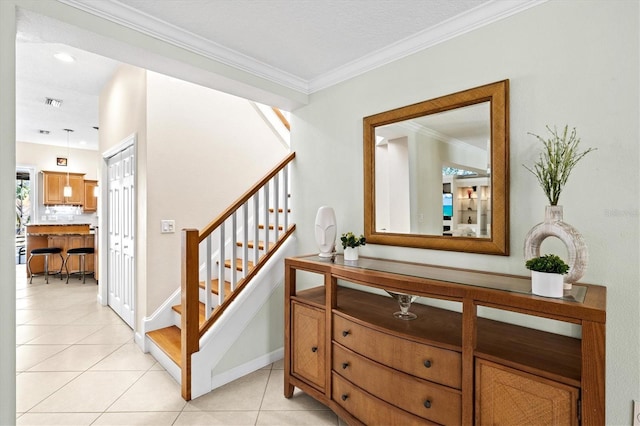 interior space featuring light tile patterned flooring, visible vents, baseboards, stairs, and crown molding