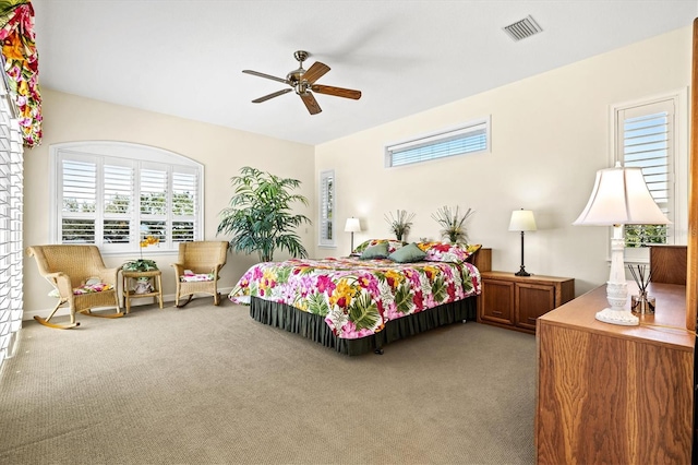 carpeted bedroom with ceiling fan and visible vents