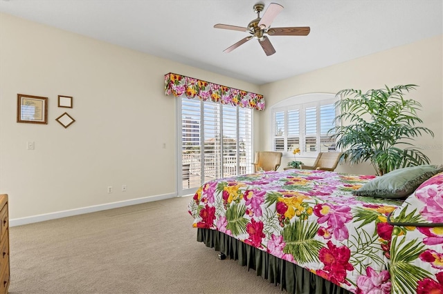 carpeted bedroom with a ceiling fan, access to outside, and baseboards