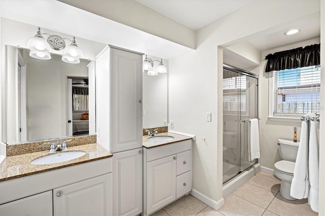 full bathroom with tile patterned flooring, a sink, a shower stall, and toilet