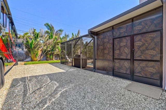 view of patio / terrace with fence and a lanai