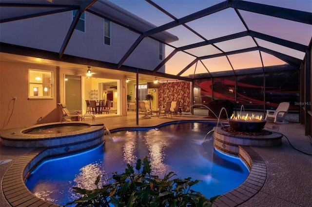 view of pool featuring an outdoor fire pit, a lanai, a patio, and a pool with connected hot tub