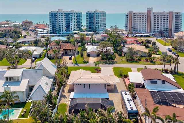 drone / aerial view featuring a view of city and a water view