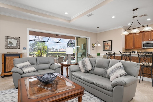 living room with light tile patterned flooring, visible vents, and crown molding