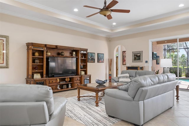 living area with arched walkways, light tile patterned flooring, and recessed lighting