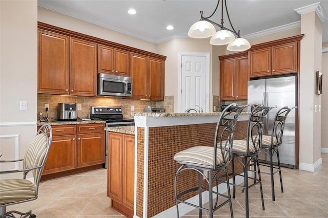 kitchen with crown molding, stainless steel appliances, tasteful backsplash, and brown cabinets