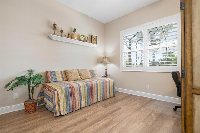 bedroom featuring wood finished floors and baseboards